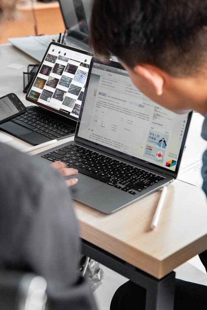 A modern office workspace with laptops and tablets showcasing collaborative tech use.