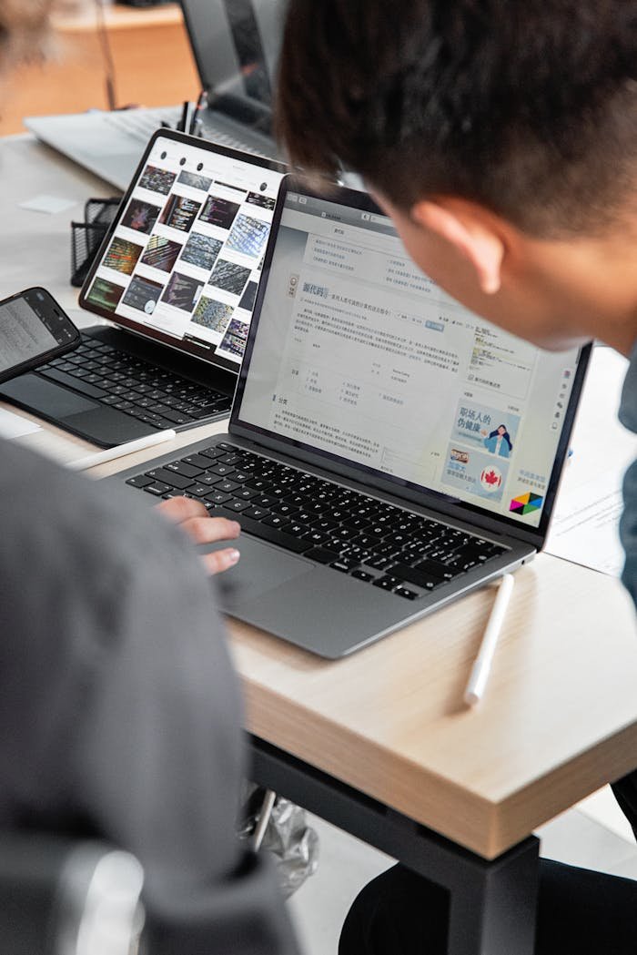 A modern office workspace with laptops and tablets showcasing collaborative tech use.